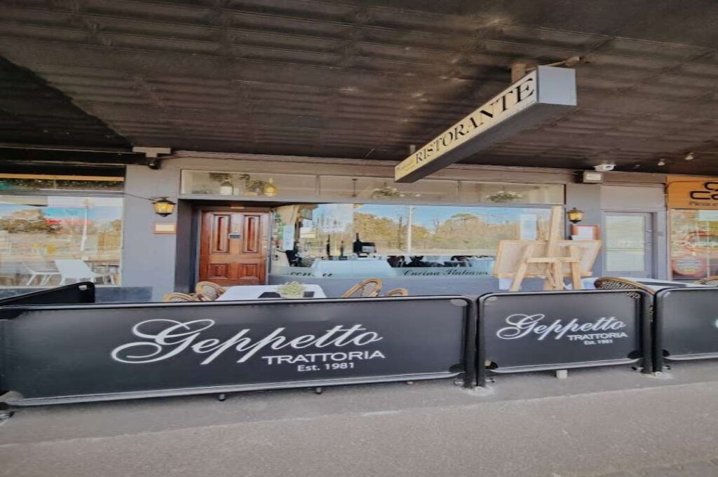 Front exterior of Geppetto Trattoria at 78a Wellington Parade in East Melbourne, featuring outdoor seating, rustic signage, and a welcoming entrance to this family-style Italian restaurant known for traditional cuisine and warm hospitality.