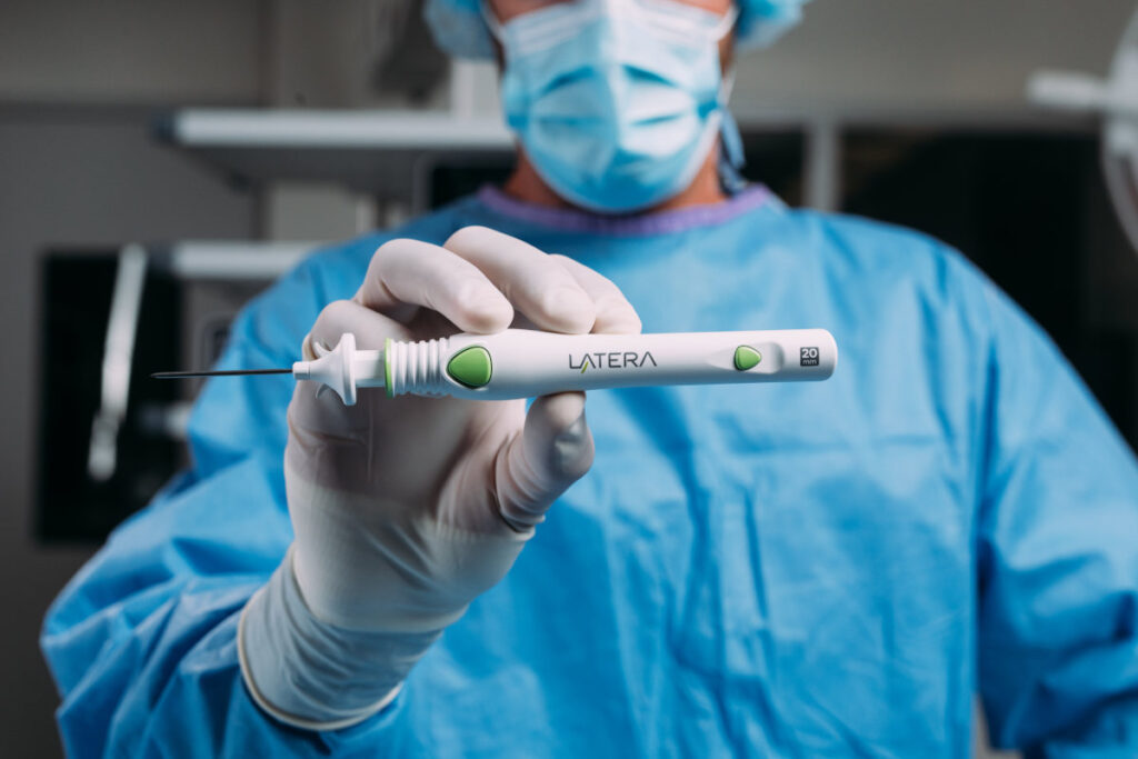 Latera Nasal Implant Melbourne - Simon Braham Holding Latera Nasal Implant Machine (scaled) Latera Nasal Implant Melbourne - Simon Braham Holding Latera Nasal Implant Machine (scaled)